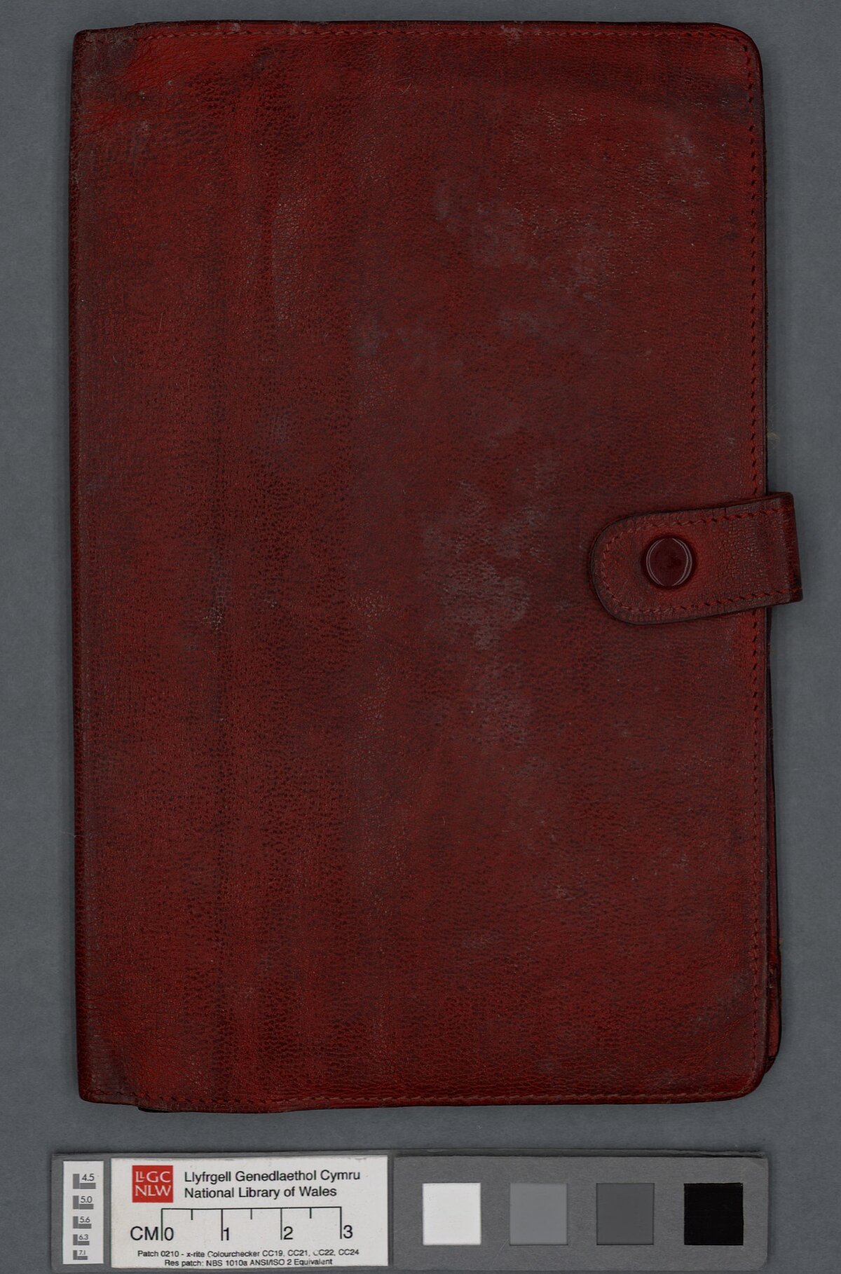 A red leather travel wallet belonging to Dylan Thomas.