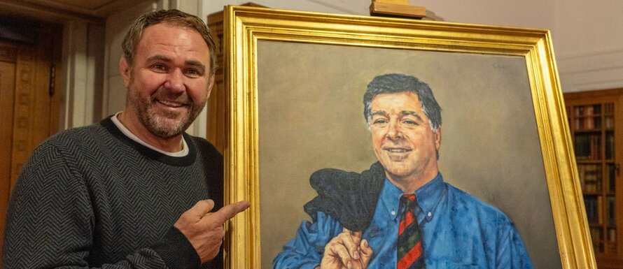 Scott Quinnell with a painting of Barry John