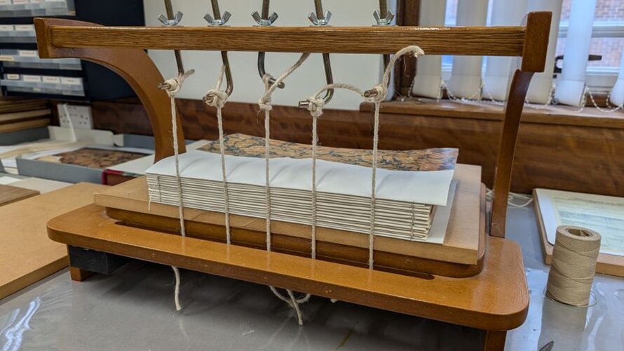 Manuscript pages gathered and pressed in a wooden binder