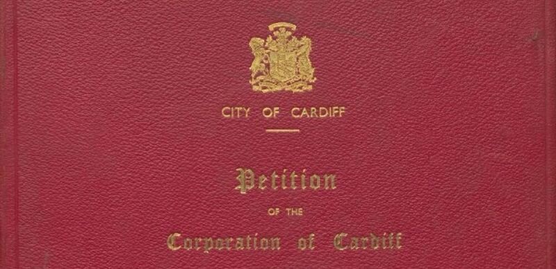 Close up of a red book cover with gold lettering reading 'City of Cardiff: Petition of the Corporation of Cardiff'