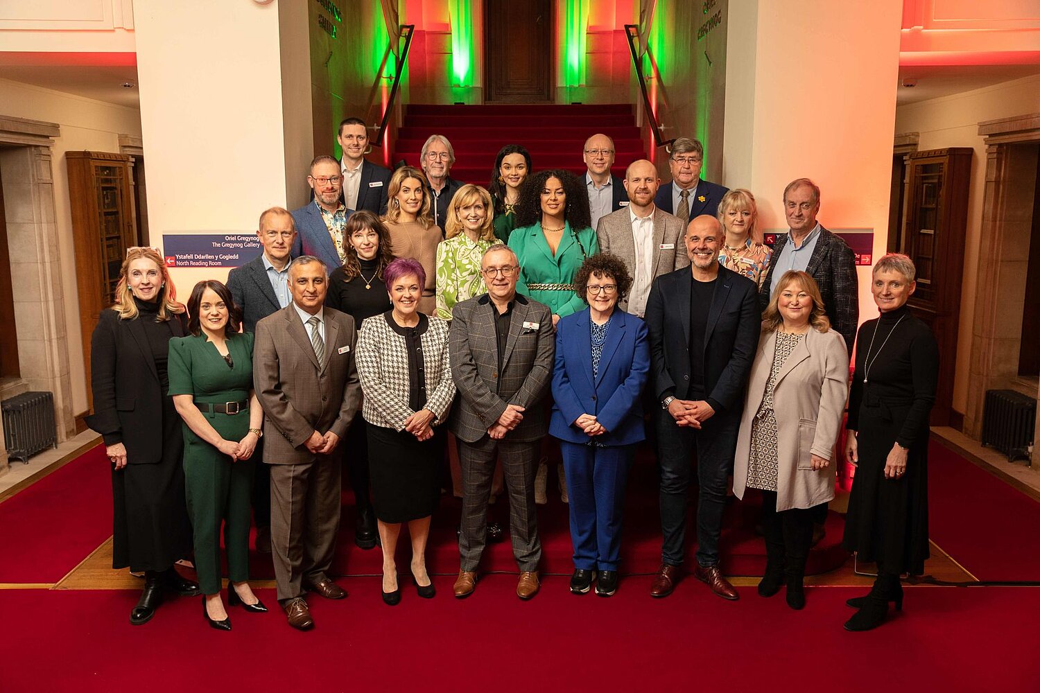 Group photographs on the main staircase in the National Library. Includes guests and staff at the opening of the Wales Broadcast Archives