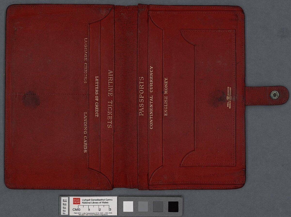 A red leather travel wallet belonging to Dylan Thomas, with inscription in gold lettering.