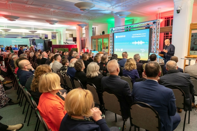 Audience listening to Jason Mohammed on stage at the opening of the Wales Broadcast Archive at the National Library of Wales h
