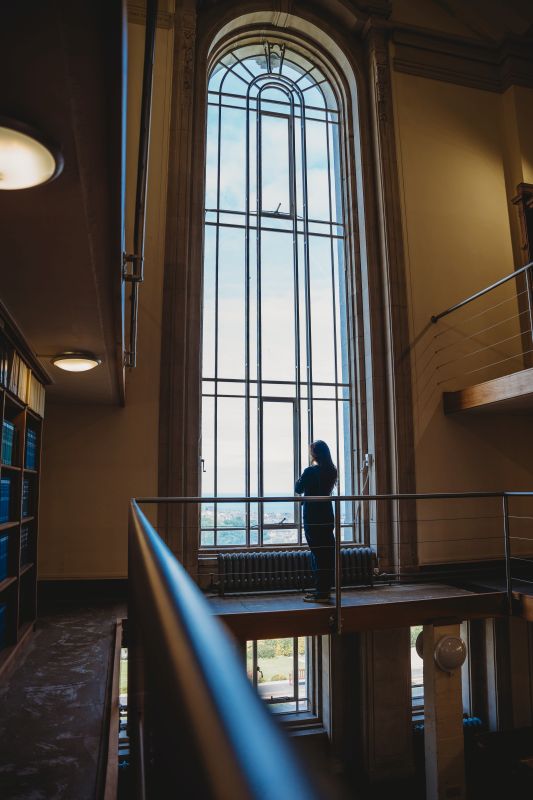 Person looking out through the window in the Reading Room
