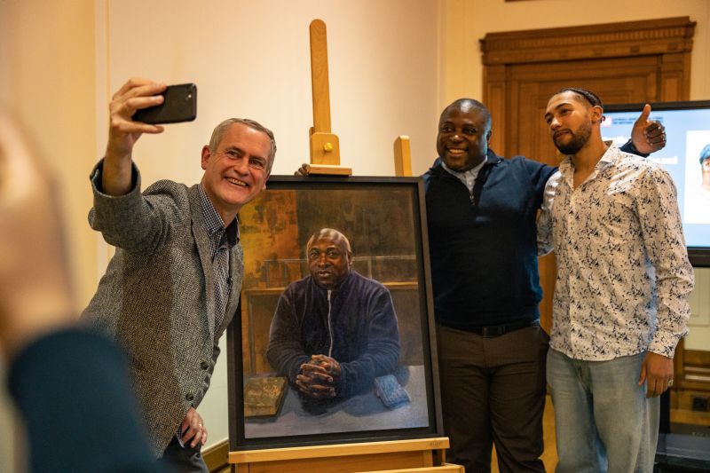 People taking a selfie with a painting