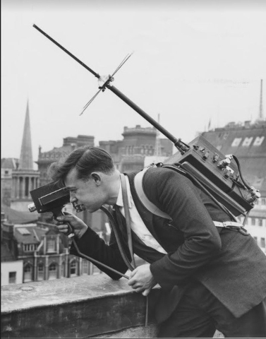 A reporter now needed to record, film and send items back to the studio - that equipment looks quite heavy! (Copyright BBC Cymru Wales) h