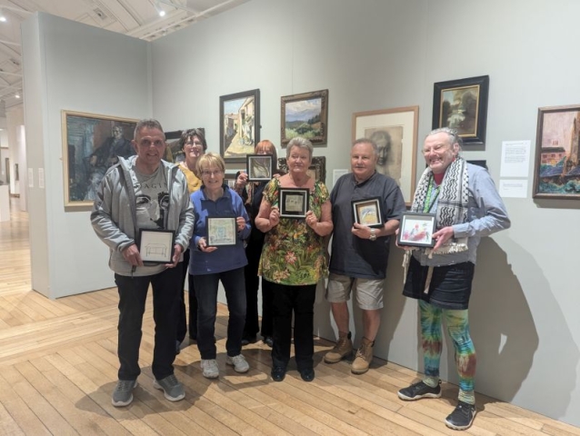 Headway Ceredigion group members showing their works inspired by the exhibition h