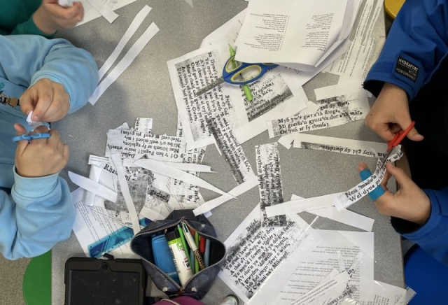 Children cutting out verses and interview transcripts cc