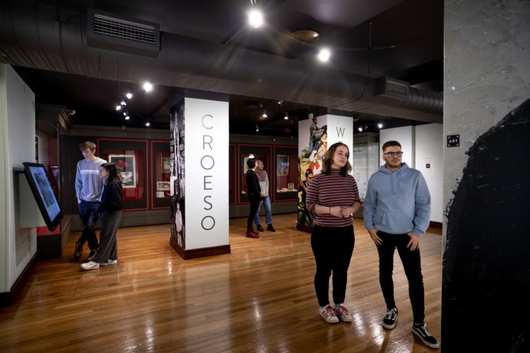 Visitors walking through an exhibition in the Library